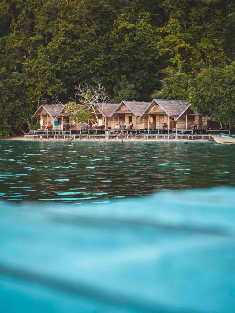 Homestays on the beach of Cape Kri in Raja Ampat, taken from the perspective of our in the ocean