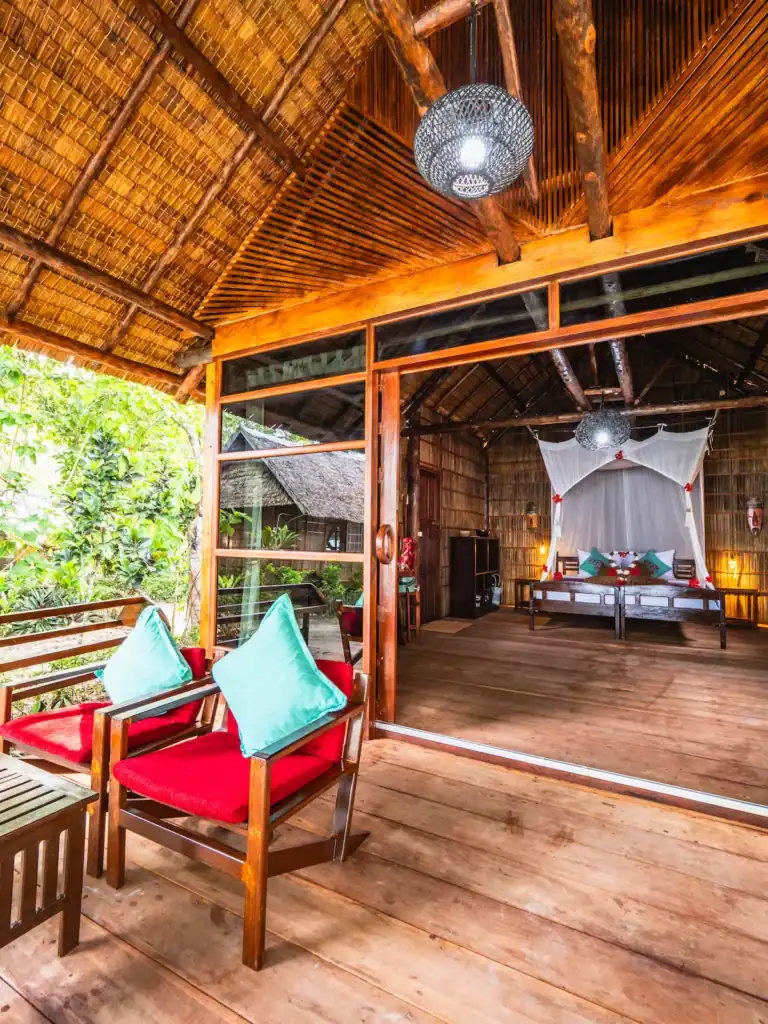 Eco-luxury garden cottage at Raja Ampat Biodiversity Resort with tropical design and mosquito-net canopy bed
