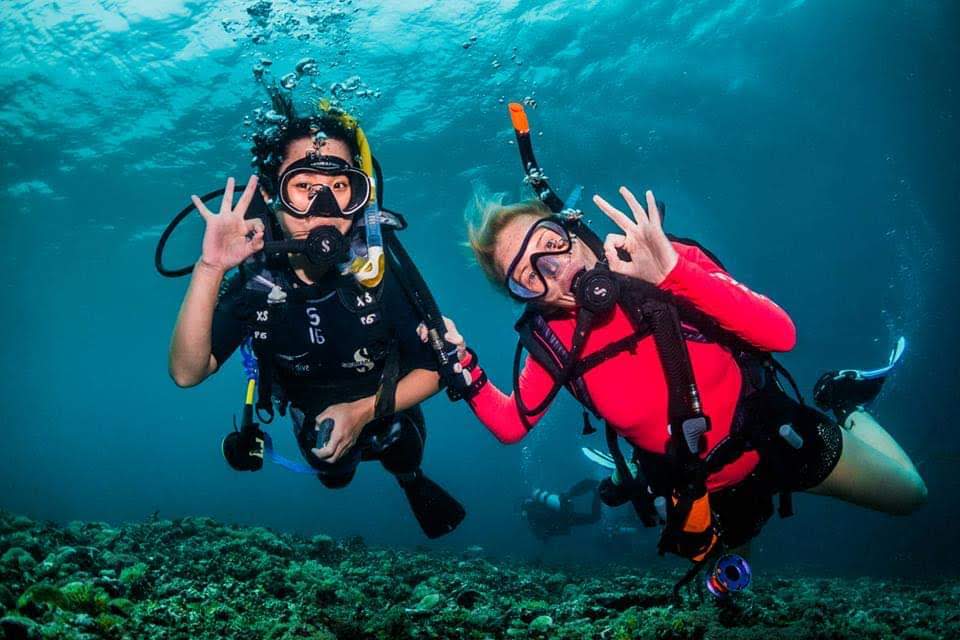 Cassie MSDT with Open Water Diver Student on Coral Reef, Scuba Diving and showing ok hand signal