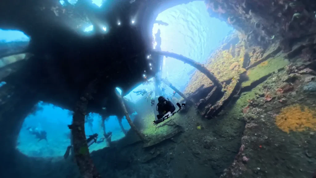 Diver silhouetted inside the interior swim-through of the USAT Liberty Wreck in Bali.