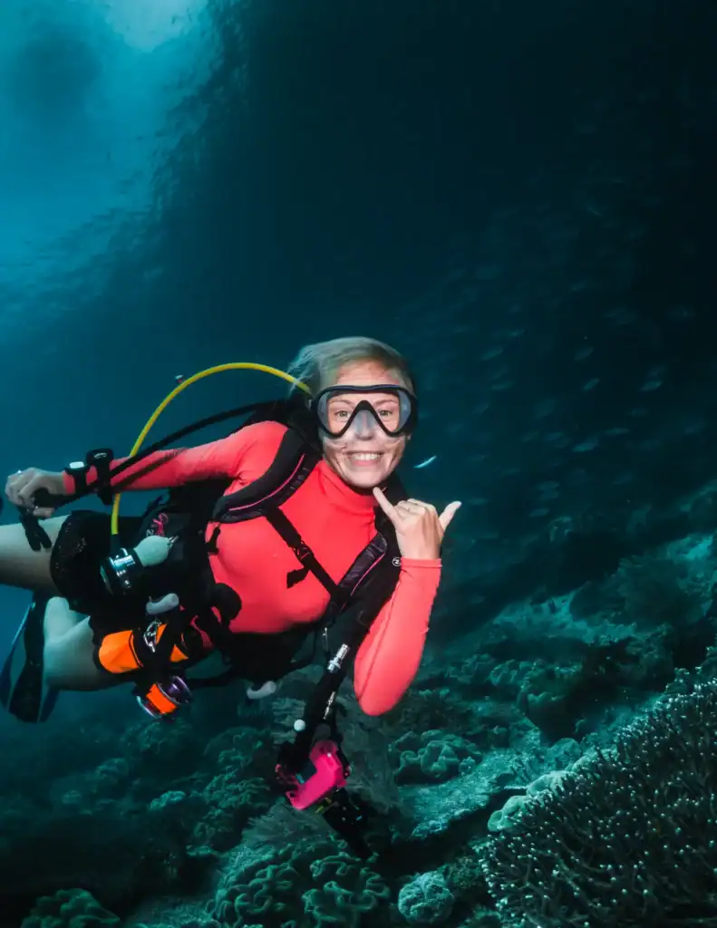 Scuba diver with properly fitted mask and strap positioned high on head underwater