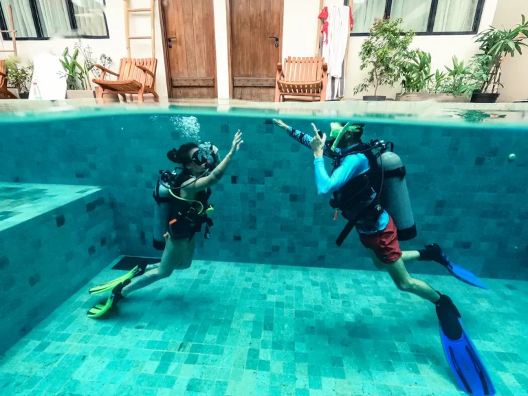 Scuba divers practising skills in a pool before diving in Kuta Lombok