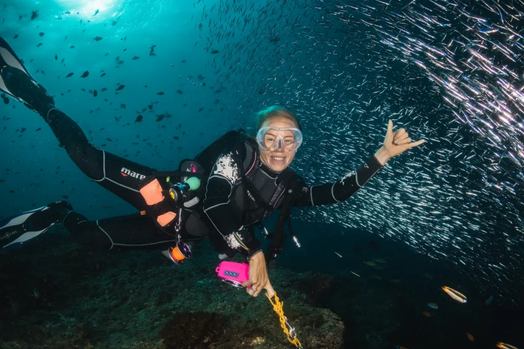 Scuba divers using reef hooks during strong current dive
