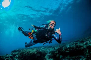 Scuba diver drift diving along a reef in ocean current