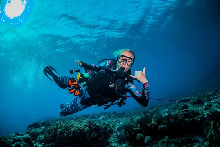 Scuba diver drift diving along a reef in ocean current