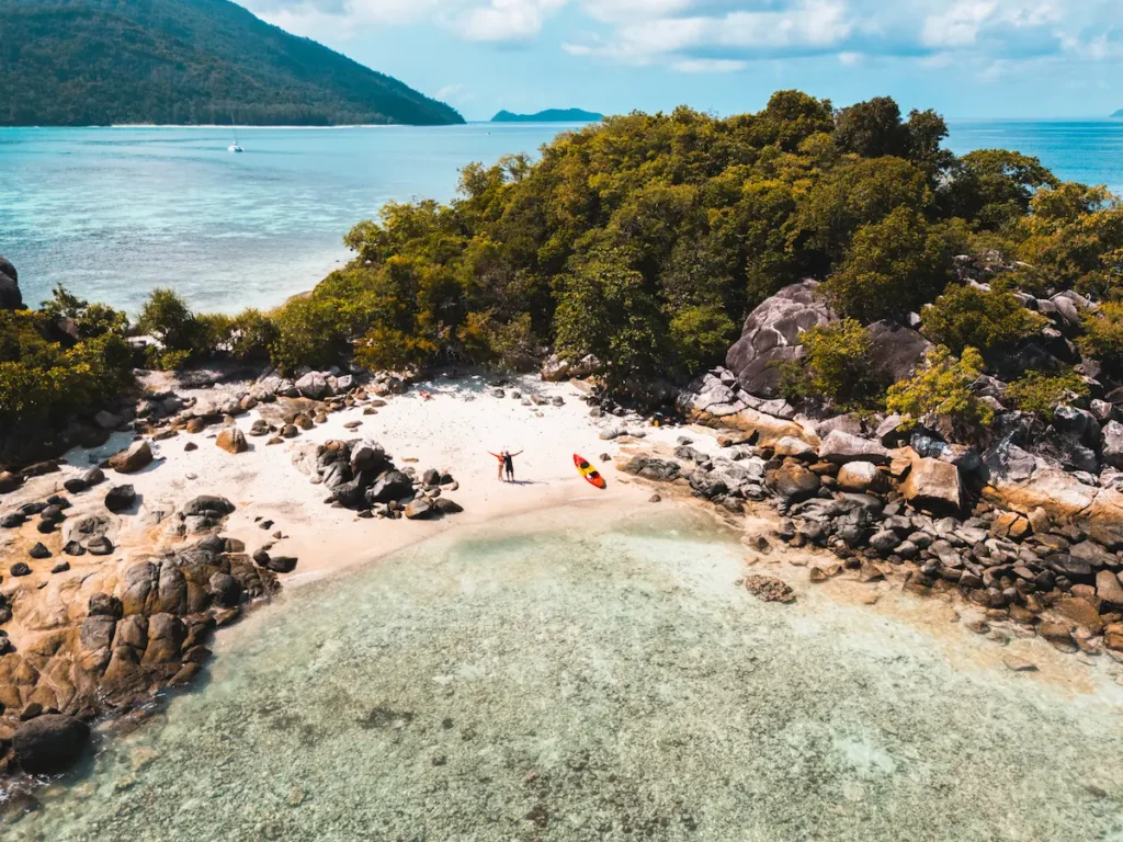 Kayaking from Koh Lipe to a small offshore island in clear turquoise water is a rainy season activity