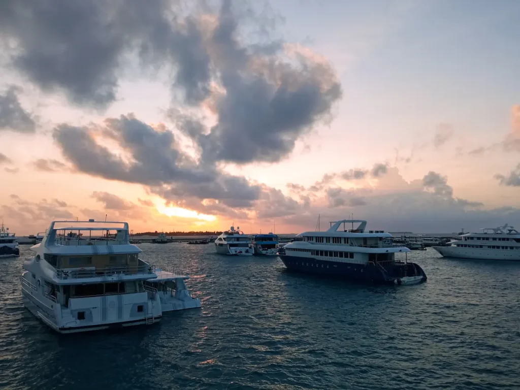 Liveaboard vessel sailing through the Maldives compared with resort and local island diving options