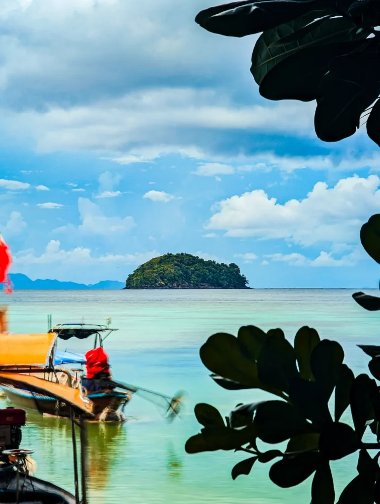 Longtail boats anchored at Sunrise Beach Koh Lipe near shallow snorkelling reef