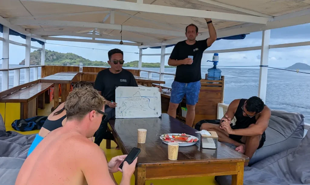 Scuba instructor delivering a pre-dive safety briefing to a group